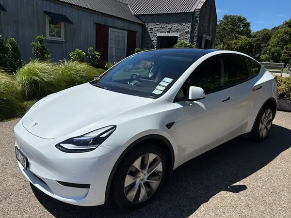 Fully electric Tesla Model Y executive taxi parked at a Hawke's Bay lodge