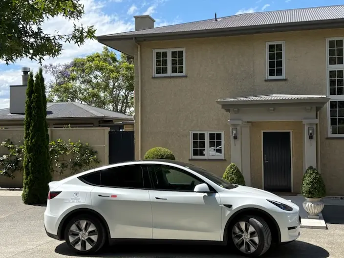 Fully electric Tesla Model Y outside a Hawke's Bay country house