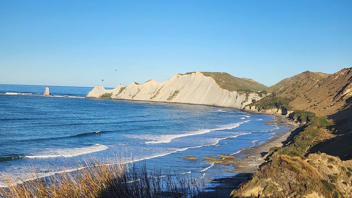 The white cliffs of Cape Kidnappers above the surf of Hawke Bay on a clear day