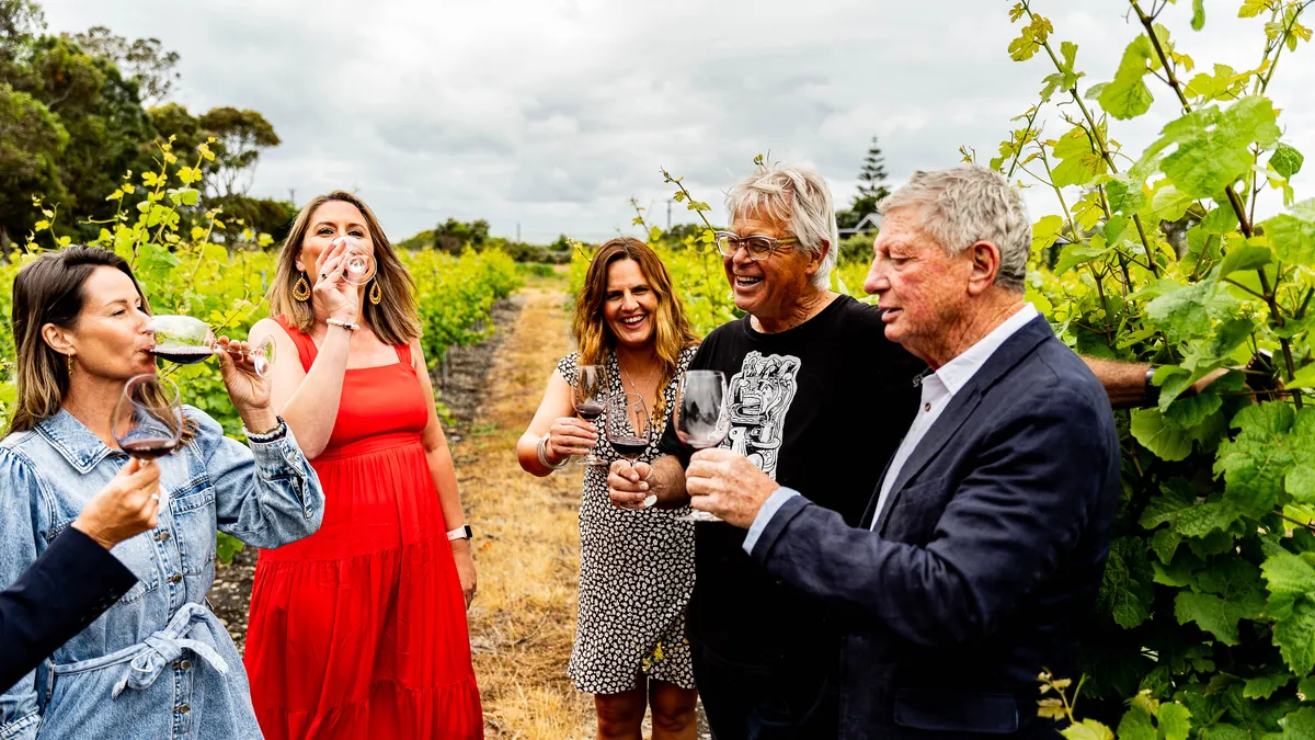 Guests tasting wine with the winemaker between the vines on the Great Wine Capital Signature tour in Hawke's Bay