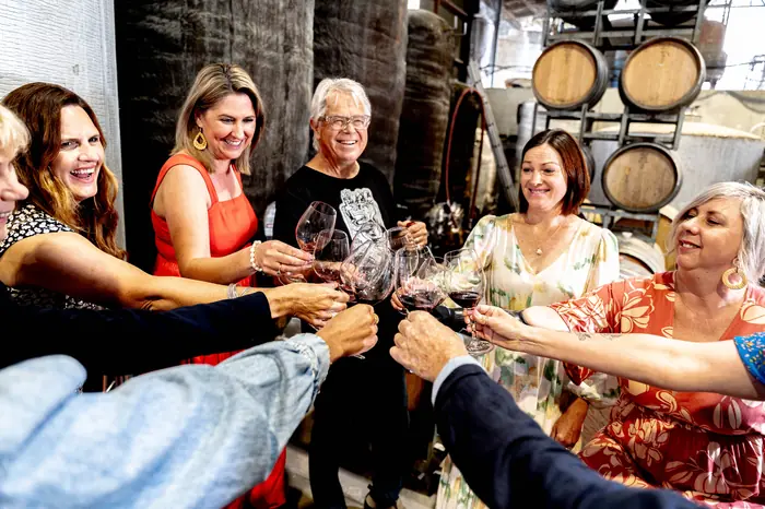 Guests tasting a barrel sample with the winemaker in a Hawke's Bay winery cellar on the Great Wine Capital Reserve