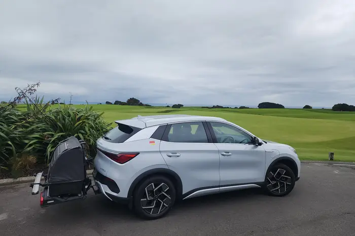 Electric BYD Atto 3 with a golf club carrier beside the fairways at Cape Kidnappers