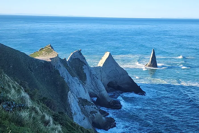 Rock pinnacles at the tip of Cape Kidnappers rising from the Pacific Ocean