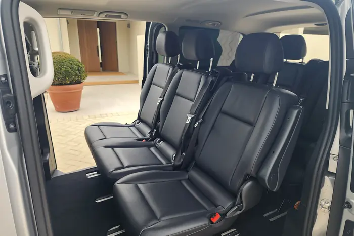 The rear cabin of the fully electric Mercedes-Benz eVito with chilled glass-bottled water
