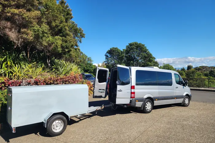 Mercedes-Benz Sprinter with the large covered luggage trailer attached