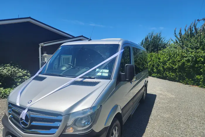 The Electric Executive Mercedes-Benz Sprinter dressed with white wedding ribbon before a Hawke's Bay wedding