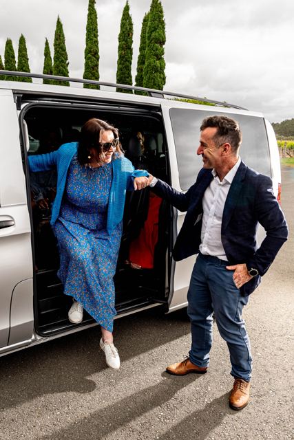A guest stepping out of the fully electric Mercedes-Benz eVito with her chauffeur